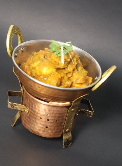 Aromatic Chicken Curry served in a copper bowl on a warmer