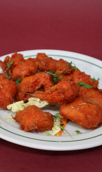 Crispy fried chicken pakoras served on a plate